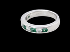 side A fine platinum half hoop eternity ring. This is a new ring*. Channel set gem stones, five bright green emeralds 2.6mm each (0.54 carats total)