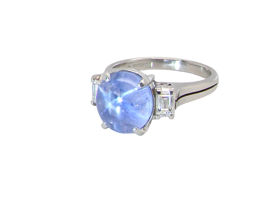 side A fine platinum* ring. Features a lovely sky blue sapphire with 'star sapphire ' chatoyancy , measures 10x9mm, (est 4 carats) held by four claws, cabouchon cut