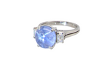 side A fine platinum* ring. Features a lovely sky blue sapphire with 'star sapphire ' chatoyancy , measures 10x9mm, (est 4 carats) held by four claws, cabouchon cut
