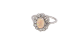side A fine vintage cluster ring. Features to the centre an oval shaped opal, with excellent play of colour, pink to one way, vibrant green to the other with flashes of electric blue also within the body of the gem.
