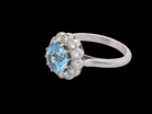side A fine vintage cluster ring centred with a deep blue aquamarine, measuring approximately 8mm and estimated at 2 carats, securely claw set.