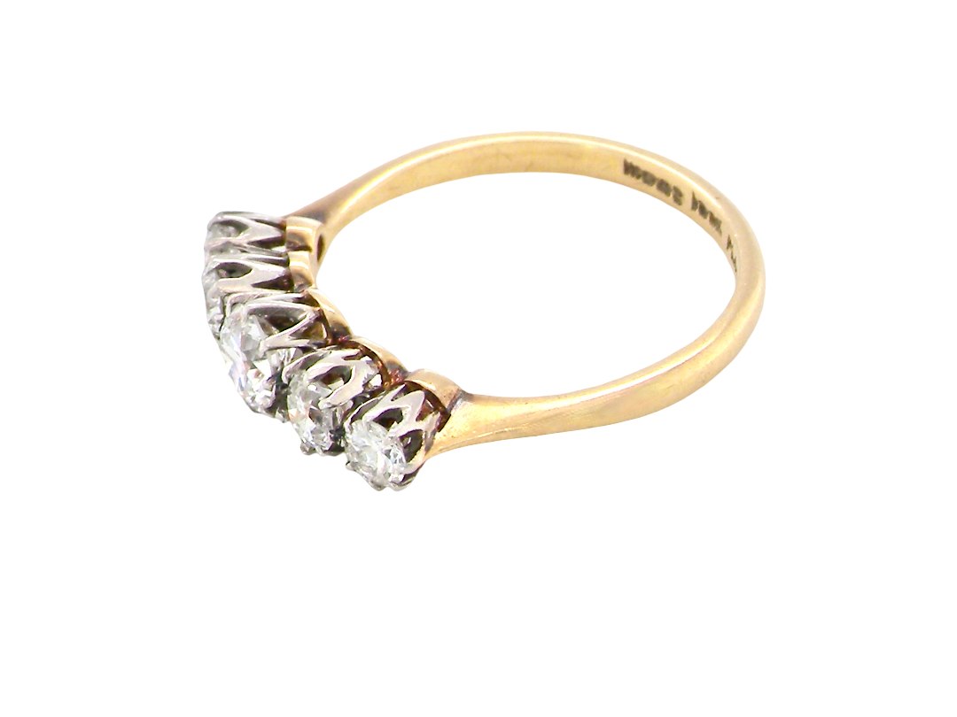 A vintage yellow gold ring with a five-stone diamond cluster setting, photographed on a clean white background.
