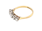 A vintage yellow gold ring with a five-stone diamond cluster setting, photographed on a clean white background.