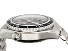 Close-up side view of a stainless steel wristwatch with a black bezel, silver case, and metal link bracelet on a white background.