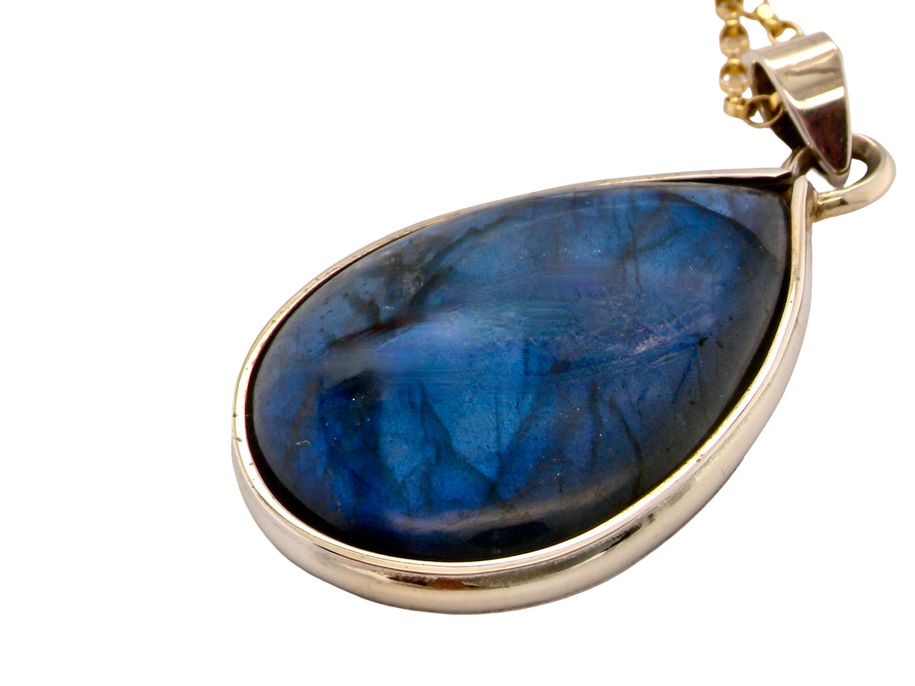 Blue teardrop pendant on a gold chain against a white background