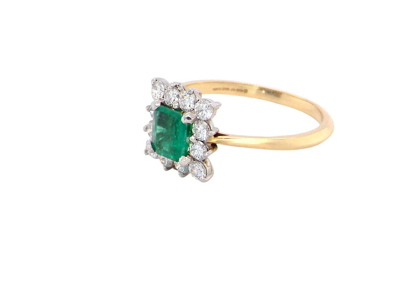 side A lovely cluster ring that features to the centre a rectangle shaped emerald, 7x5mm. Shows a deep grass green colour which does have natural inclusions common with most emeralds, but the depth of colour is impressive.