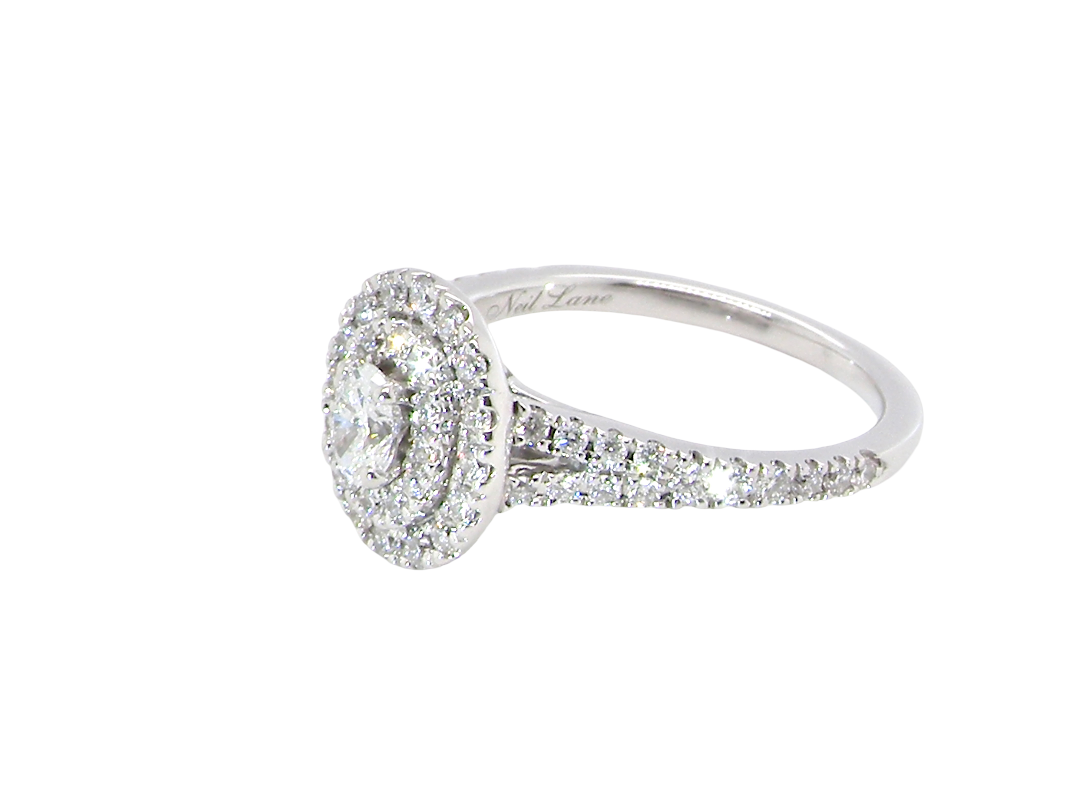side A new diamond cluster ring* An oval diamond halo cluster ring. Set with brilliant cut white diamonds, colour H-k, clarity Si.