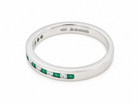 An eternity-style band ring featuring a channel setting of green emerald-cut gemstones and clear round stones, shown on a clean white background. The inside of the band is stamped with 'NBD'.