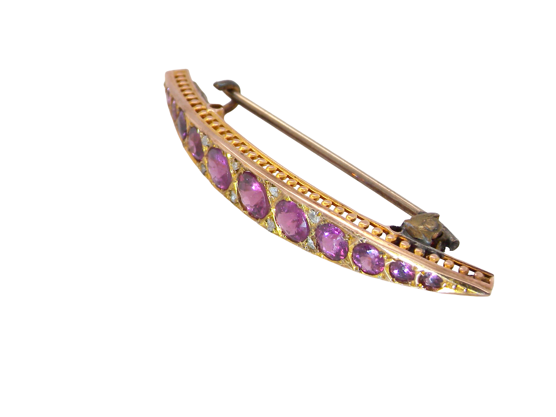 side A pretty Victorian crescent shaped brooch. The principal stones are almandine garnets