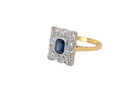 side A rectangular cluster ring that features in its centre a cushion shaped dark blue sapphire, that measures 5x3.5mm (est 0.30 carats)