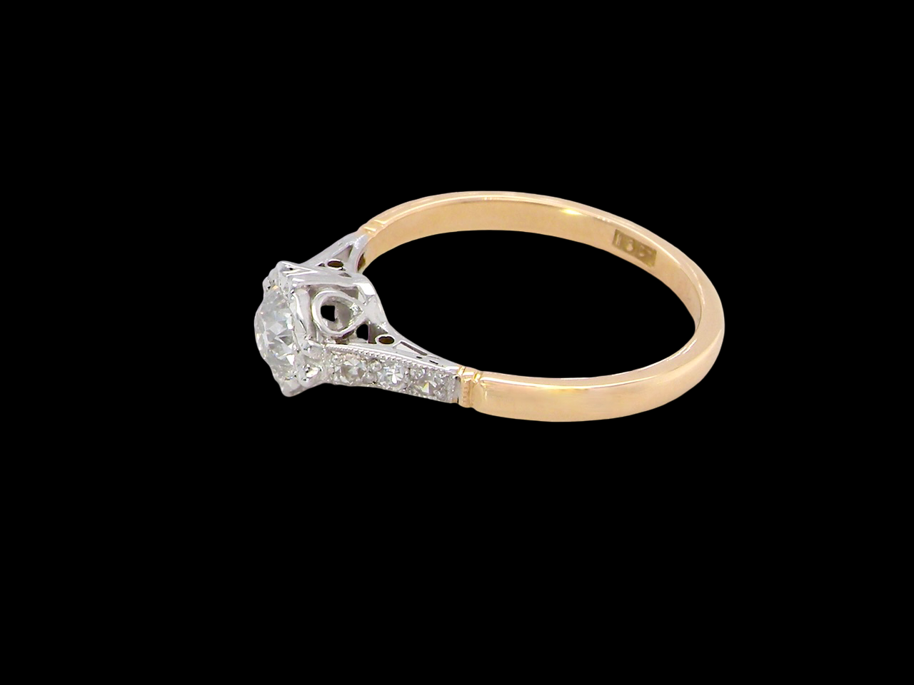 side A ring that features an old brilliant-cut white diamond 