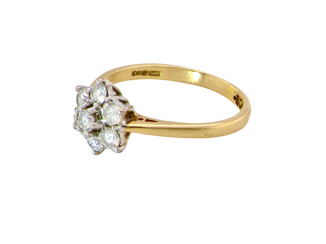 side A small cluster ring set with seven bright white brilliant cut white diamonds.

Head measures 8.5mm, each diamond measures 2.8mm (total 0.50 carats