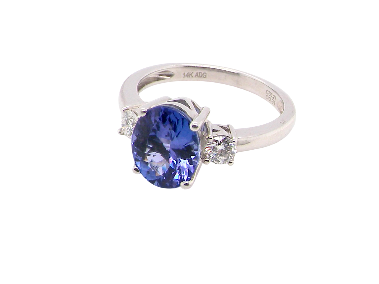 side A three stone ring that features an impressive tanzanite centre stone that measures 10x8mm (3.21 carats confirmed) AAA colour.&nbsp;
