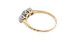 side A three stone ring, the centre stone an old brilliant cut white diamond 4.6mm (est 0.38 carats) colour i-j, clarity Si, claw set in platinum.