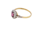 side A traditional cluster ring. Features to the centre a dark pink red ruby, oval cut 6x4mm (0.50 carats)