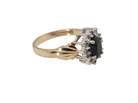 side A traditional cluster ring that features to the centre a dark black blue oval cut sapphire 7x5mm (est 3/4 ct) claw set.