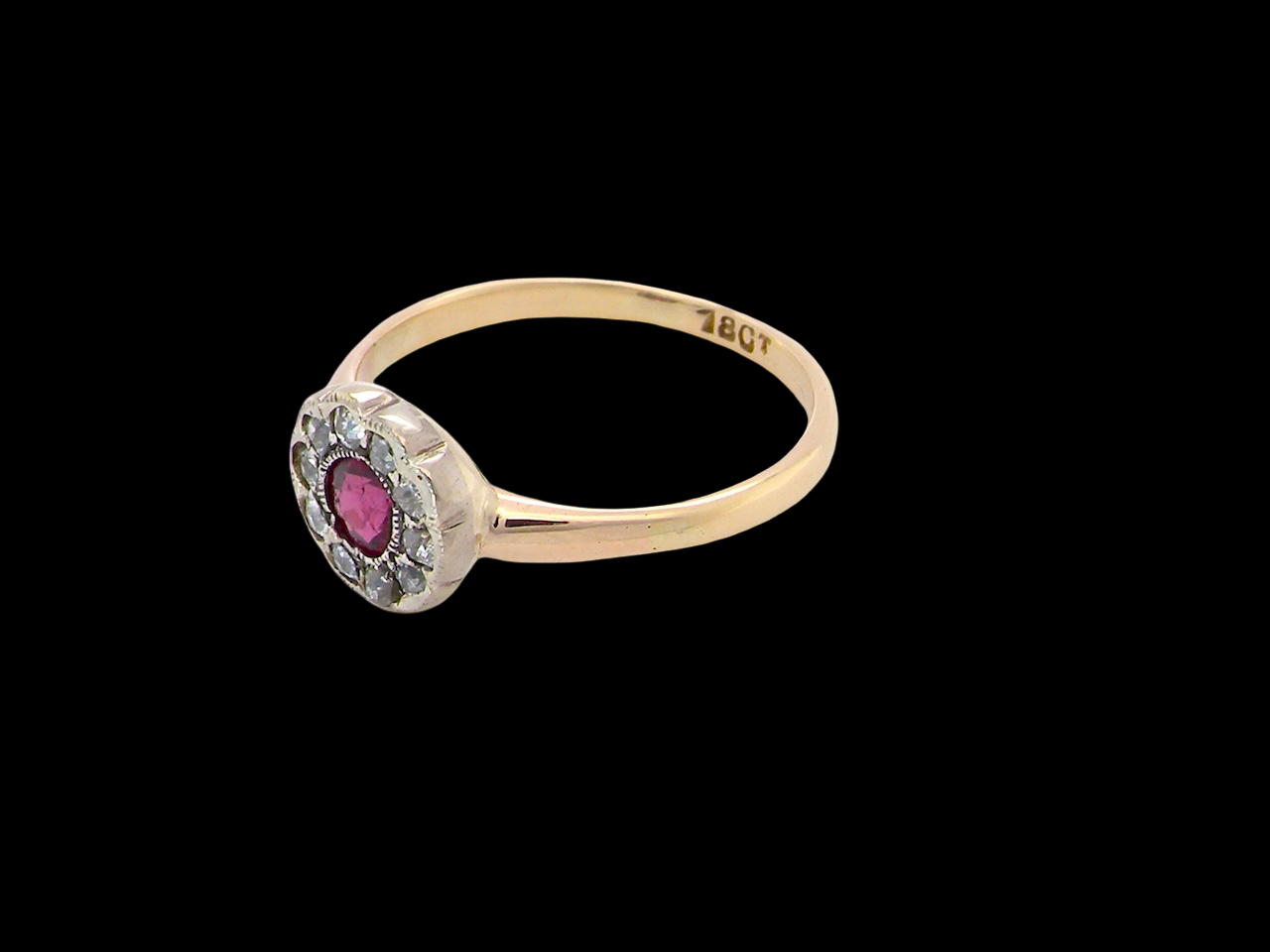 side A very pretty vintage daisy cluster ring. Features to the centre a round pink red ruby that measures 4mm, and is mille grain set.
