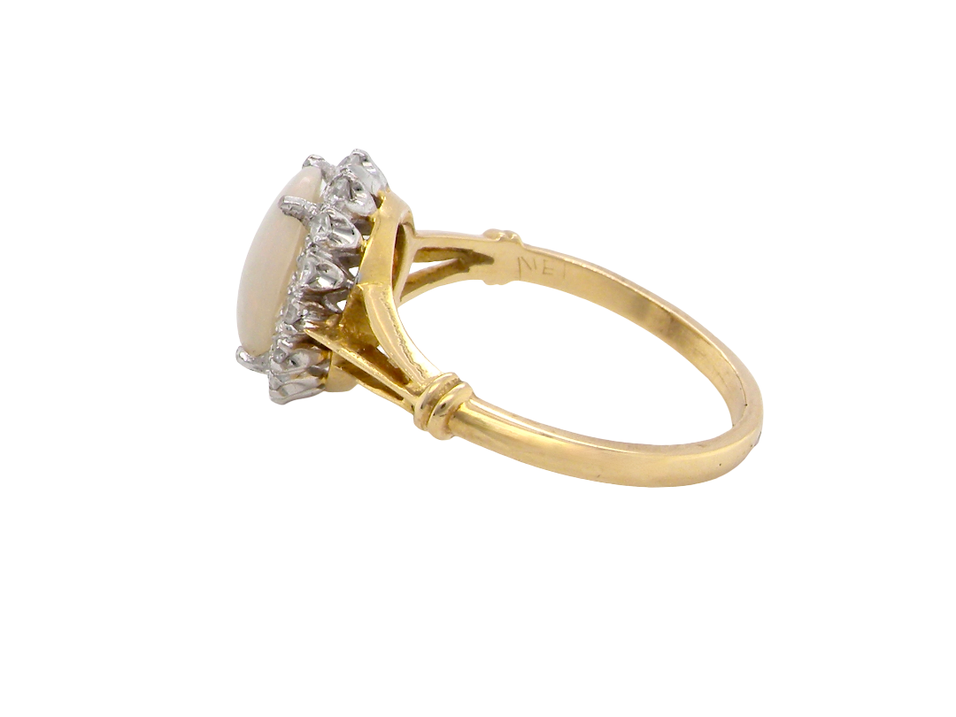 side A vintage cluster ring. Features an oval white opal, measures 10x8mm, with a good play of colour.