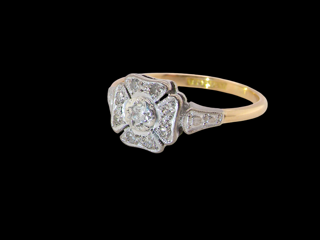 side A vintage diamond cluster ring. Shaped like a four leaf clover, each leaf is pavé set with small white diamonds, two each x 1.5mm. Centre diamond 2.4mm. (total estimated total 0.17 carats)