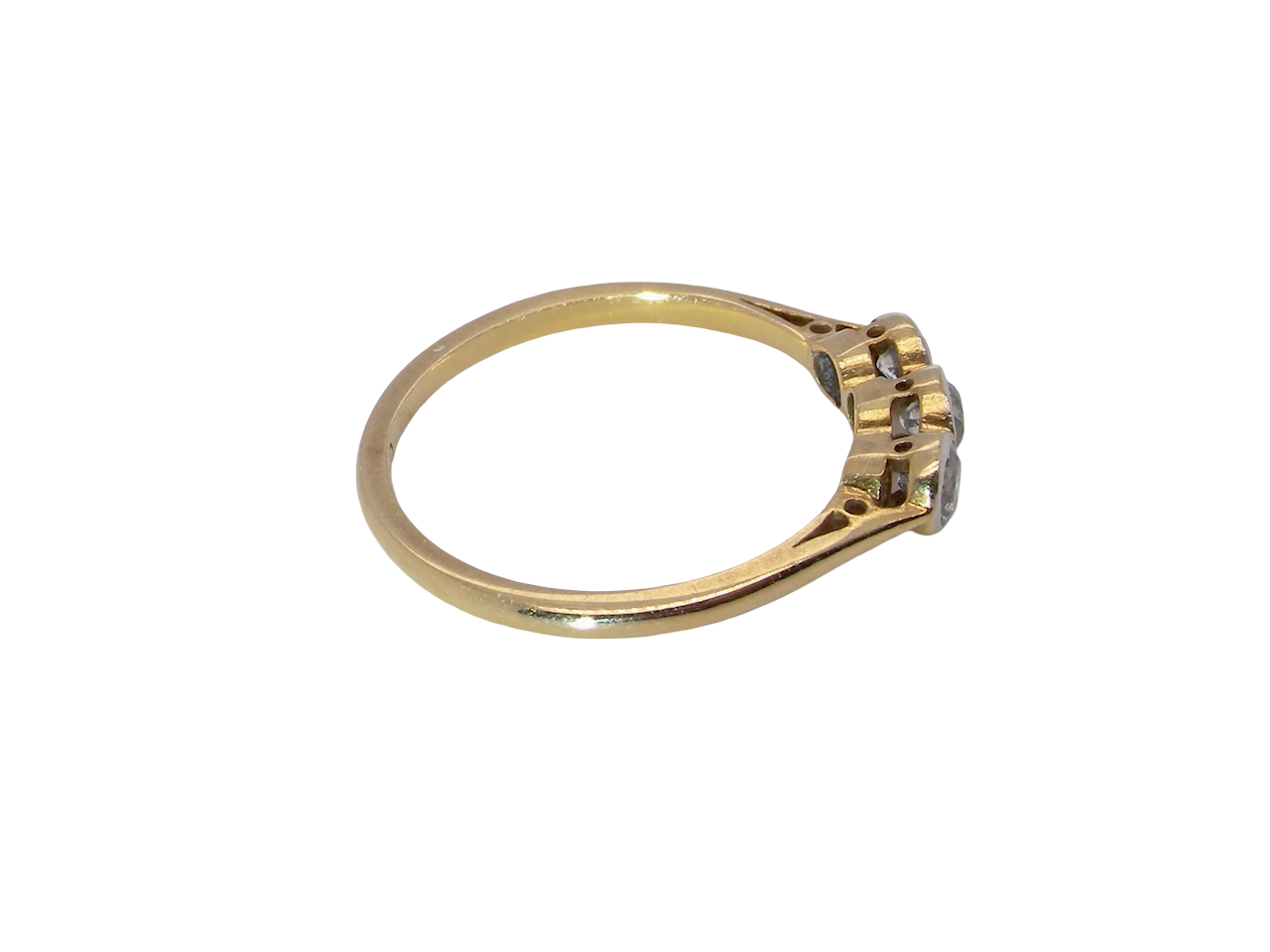 side A vintage early 20th century trilogy ring. Set with three old cut diamonds, centre stone 3.8mm, and each side a 3.6mm diamond (total carat weight estimated at 0.55 carats)
