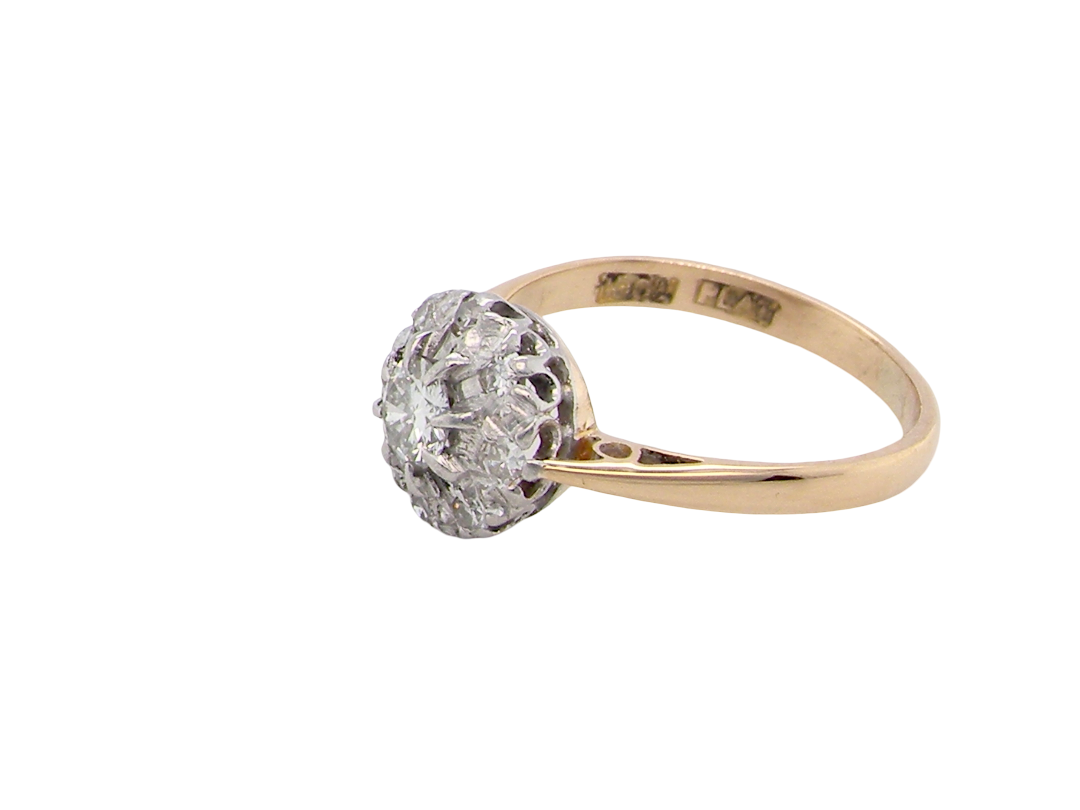 side A vintage mid 20th century cluster ring. Principle stone a brilliant cut white diamond, 4mm (0.25 carats est) clarity i-j, clarity Si.