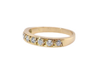 side An 18 carat gold half-hoop eternity ring, set with eight brilliant-cut white diamonds
