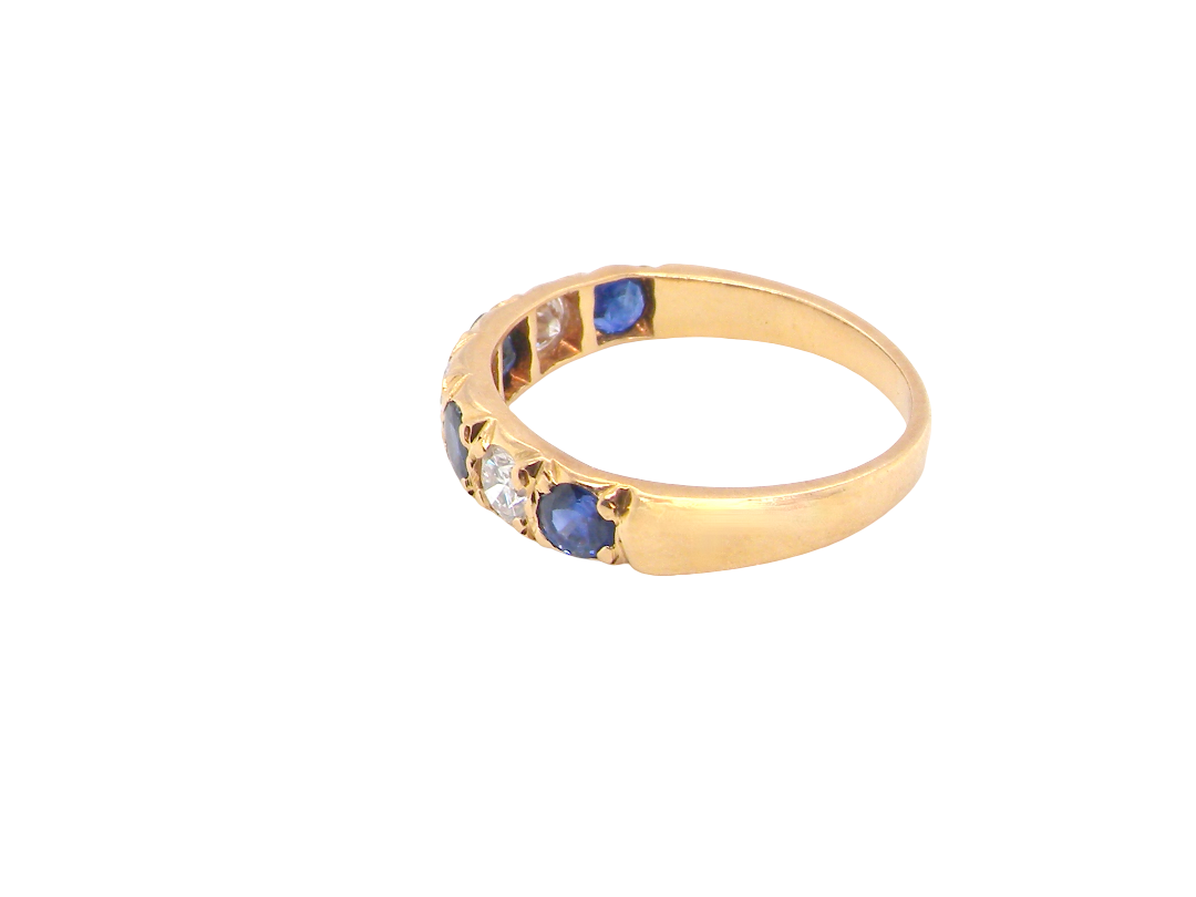 side An 18 carat gold half hoop eternity ring. Set with four sapphires each 3.4mm (0.15 carats) and three diamonds, brilliant cut, 3.4mm (0.15 carats).