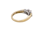 A two-tone diamond ring with a yellow gold band and a silver-colored setting featuring three prongs, photographed on a solid white background.