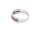 side An 18 carat white gold half hoop ring. A triple row design with a line of channel set calibre cut rubies running along the centre , to a total carat weight of 0.97 carats.
