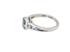 side An 18 carat white gold ring, features a rectangular step cut aquamarine, measures 7x5mm (st one carat) sky blue, fine clarity. Rim setting.