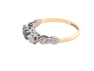 side An early 20th century engagement ring. The centre stone a dark blue sapphire