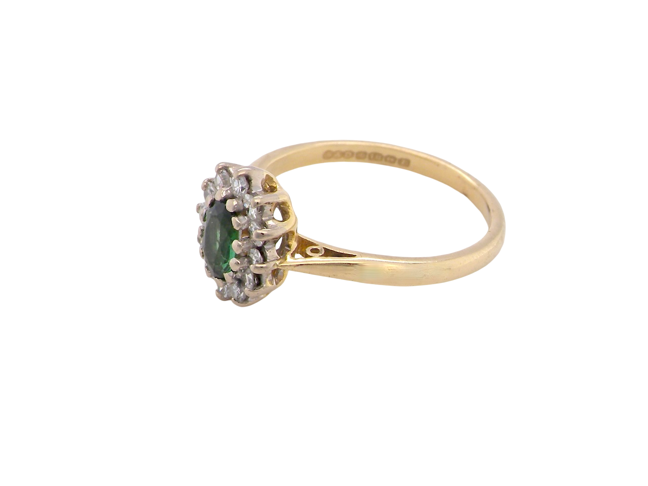 side An elegant 18 carat gold cluster ring featuring a beautifully proportioned 6 × 4mm green tourmaline 