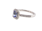 side An elegant cluster ring that features to the centre a rectangular tanzanite gemstone that measures 6x4mm (est 0.50 carats) AAA colour.