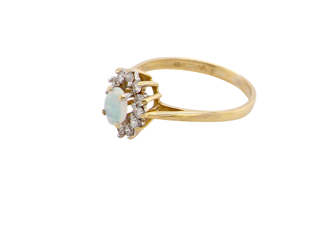 side An elegant&nbsp; cluster ring featuring a white opal centre stone measuring 6 × 4mm, displaying a lively and attractive play of colour.