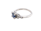 side An elegant vintage-style platinum ring showcasing a beautifully proportioned round sapphire with a soft mid to light cornflower blue hue. The sapphire measures 5.6mm in diameter (approx. 0.80 carats) 