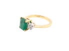 side An exceptional three-stone ring featuring a vibrant step-cut emerald to the centre, measuring 8.6 x 7.0mm and weighing approximately 2.10 carats. The emerald displays a beautiful grass-green colour and is secured in a classic four-claw setting.