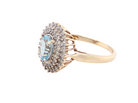 side An impressive cluster ring that features to the centre an oval cut blue topaz gemstone, 8x6mm sky blue colour.

Complimented by an outer double halo of diamonds