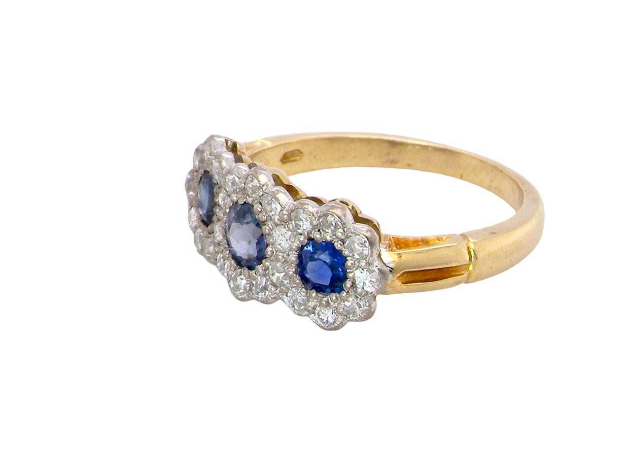 side An impressive multi cluster ring. Set with three cornflower blue sapphires to each centre, 4.3mm, and each side a 3.3mm sapphire. Based on an Edwardian design
