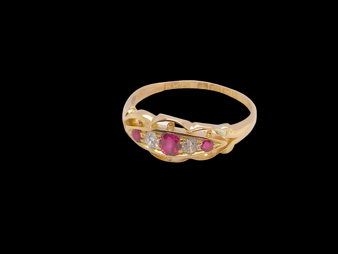 side Set with three bright rubies, centre 3x2.6mm, each end a 2mm ruby. Each side of the centre stone an old brilliant cut white diamond 2.8mm (est 0.08 carats) . Head measures 17x7mm, weight 3.4grams.&nbsp;