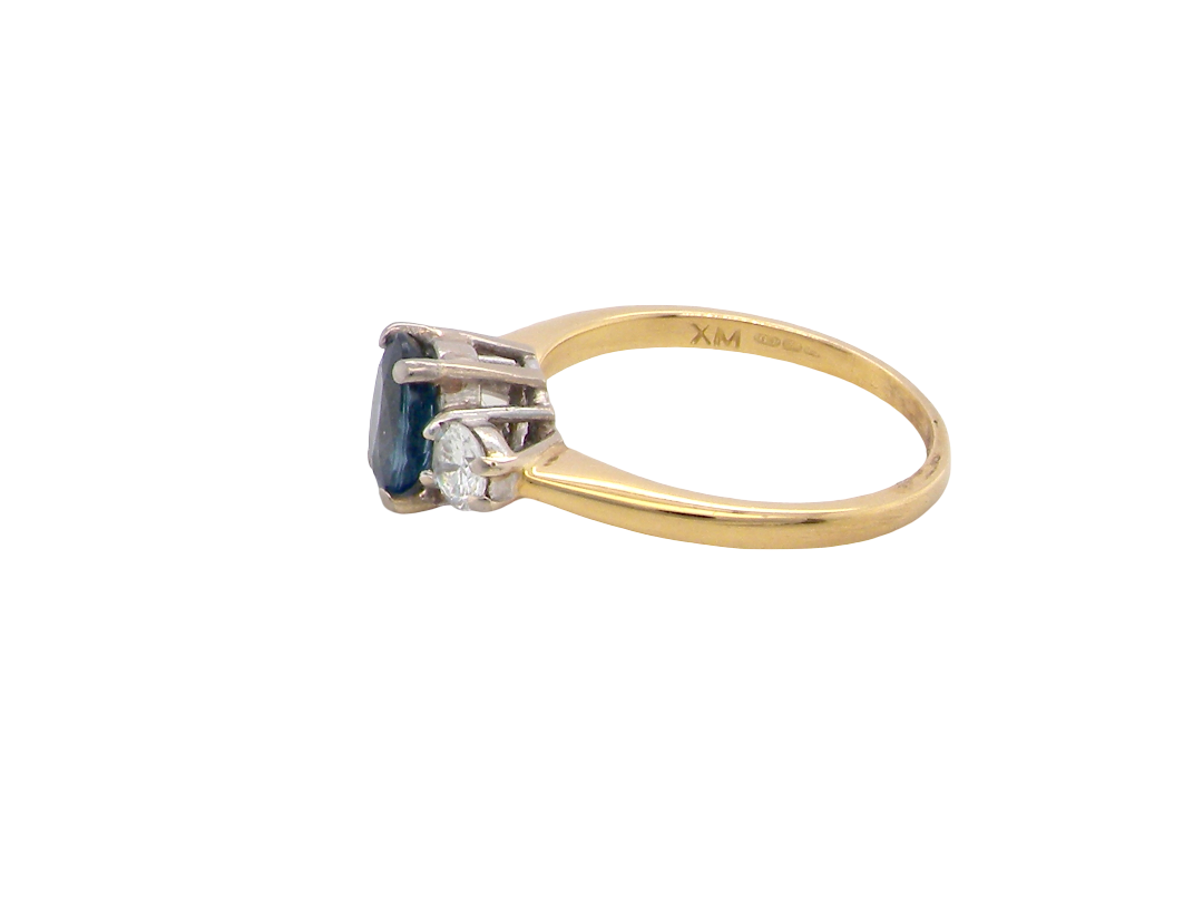 side The iconic trilogy ring, featuring an oval cut sapphire centre stone, with a pleasing mid blue hue set into four claws, 7x5mm (0.75 carats est)