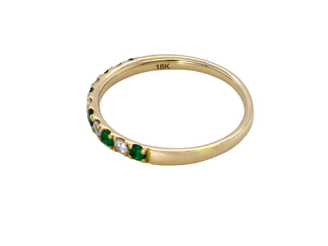 side This ring is set with six bright green emeralds, each 2mm, (est 0.25 carats) and five 2mm brilliant cut white diamonds.