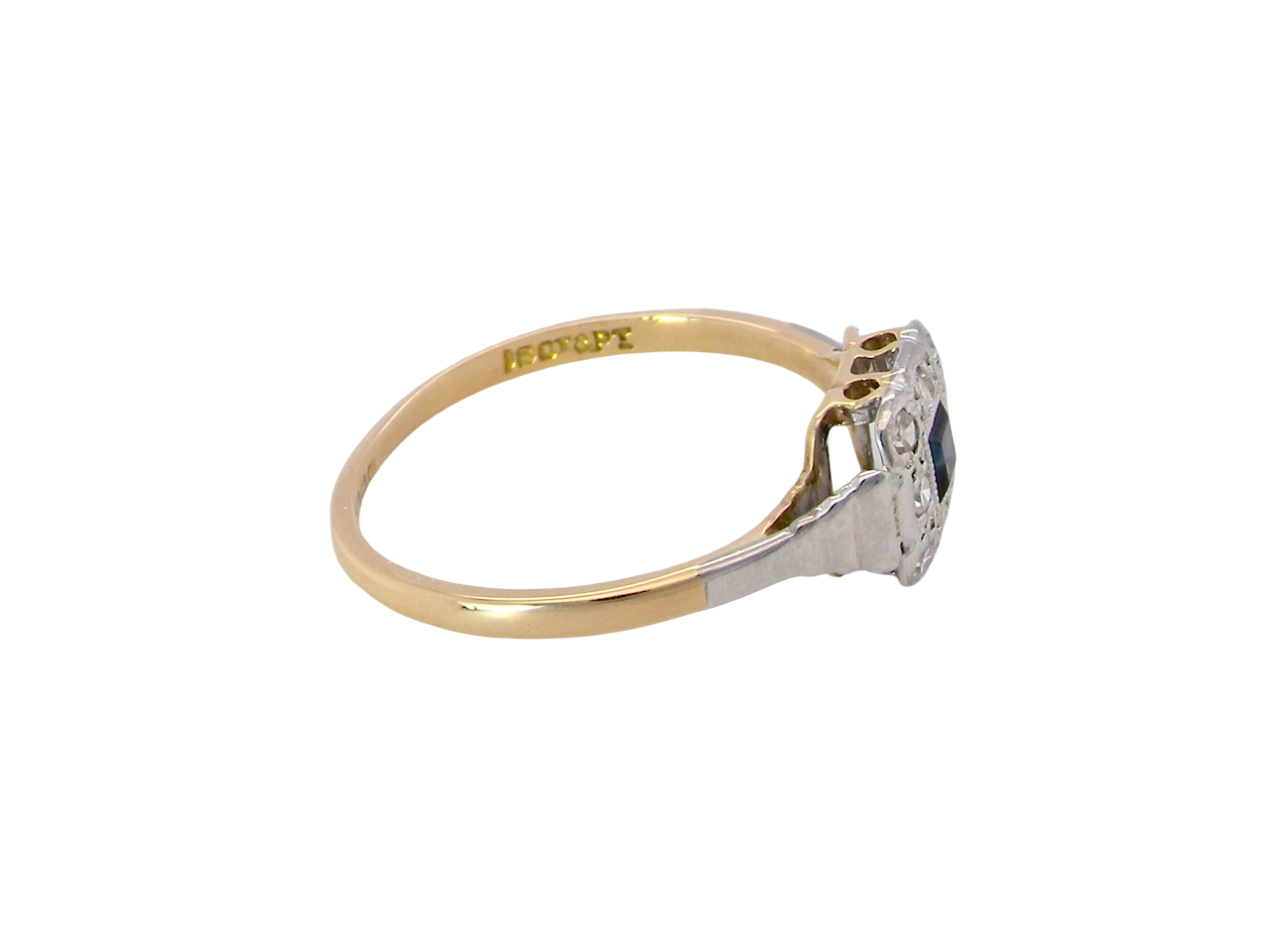 side antique cluster ring. Features a small square sapphire