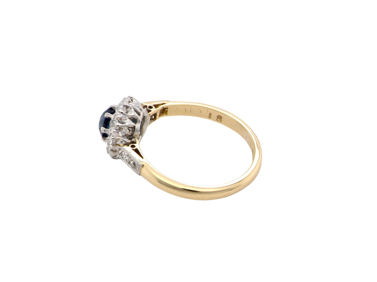 side  beautiful mid-century cluster ring featuring a round dark blue sapphire 