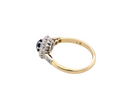 side  beautiful mid-century cluster ring featuring a round dark blue sapphire 