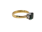 side elegant 18 carat yellow gold trilogy ring featuring a striking natural sapphire at its centre