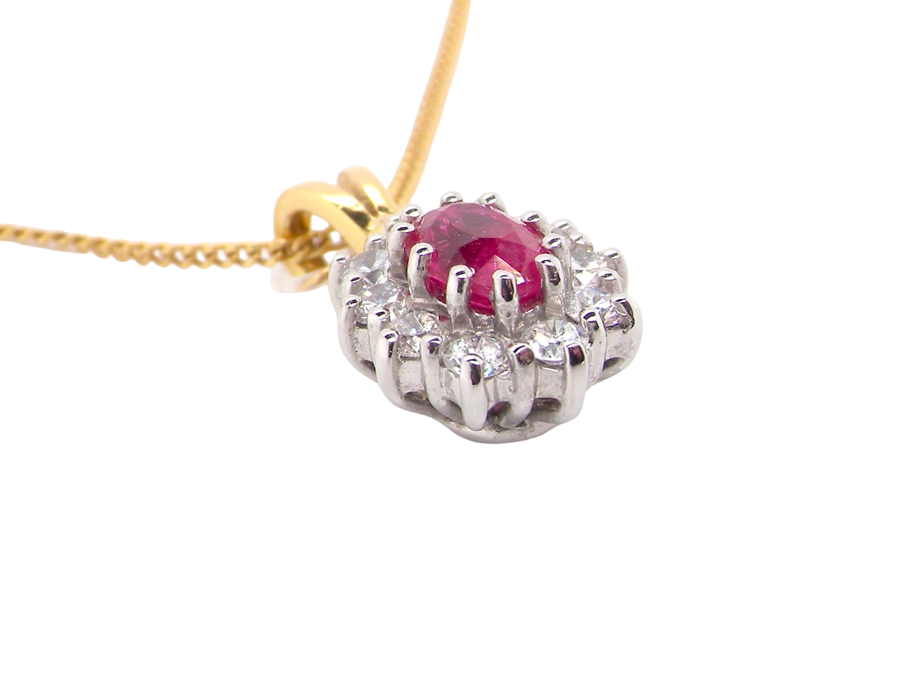side elegant pendant showcasing a vivid oval-cut raspberry-red ruby