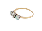 side opal A three stone ring, the centre stone an old brilliant cut white diamond 4.6mm (est 0.38 carats) colour i-j, clarity Si, claw set in platinum.