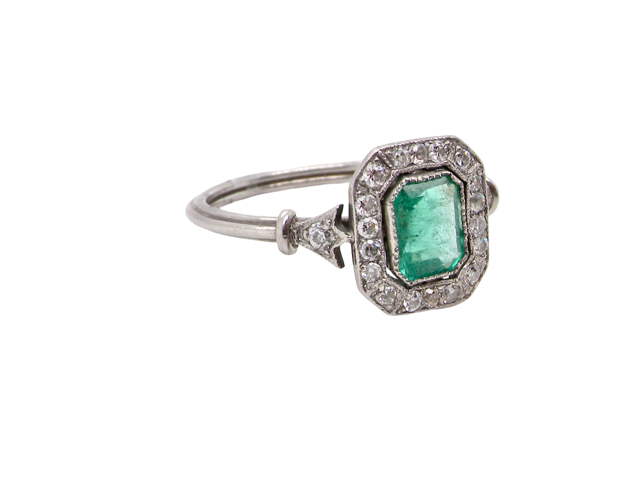 side view A beautiful Art Deco cluster ring centred with a vibrant step-cut emerald