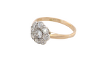 side A vintage cluster ring set with nine old brilliant cut white diamonds. Centre stone 3.7mm (est 0.18 carats) surorunded by eight 2.8mm diamonds (0.08 carats est).