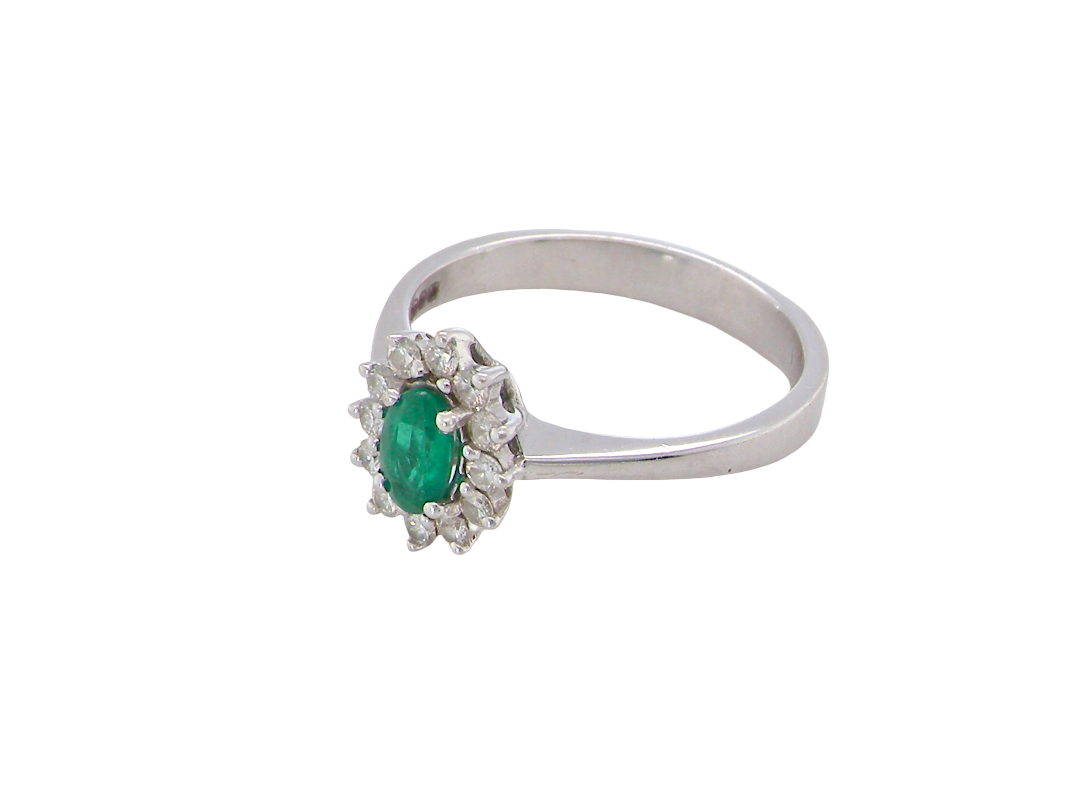 side white gold cluster ring.

Centre stone is an oval cut emerald, 6x3.7mm (just under 0.50 carats) good deep green hue.